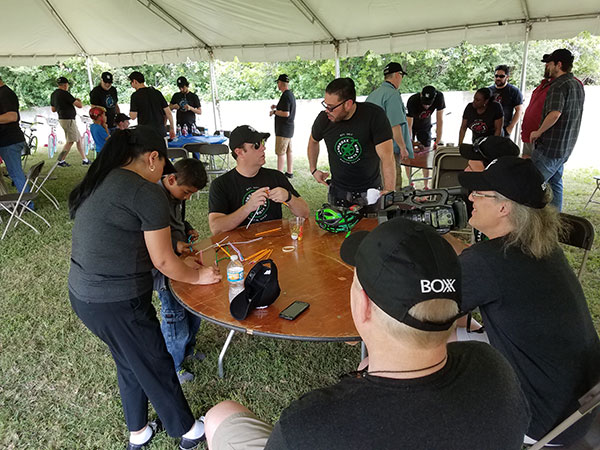 BOXX employees assembling bicycles in an outdoor tent