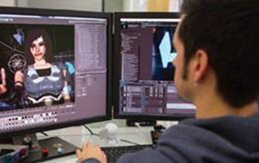 a man editing video in front of a dual monitor workstation