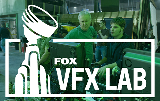 two men working at a computer on a film set, overlaid with the Fox VFX Lab Logo